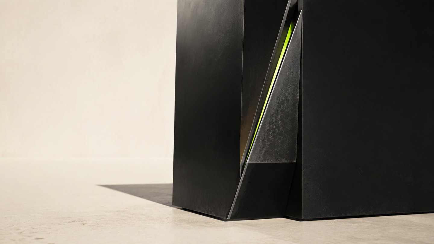 A monumental matte-black architectural structure sliced by one exact diagonal cut, with a thin lime filament embedded inside the cut.